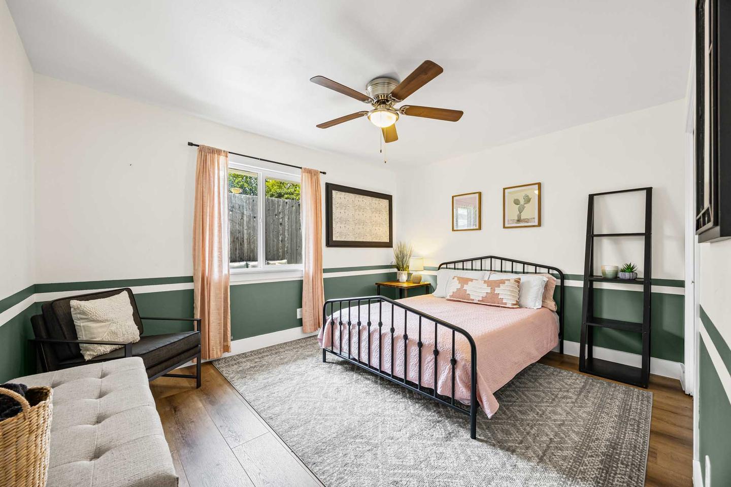 Model apartment bedroom in East Austin with a metal frame bed and light timber flooring