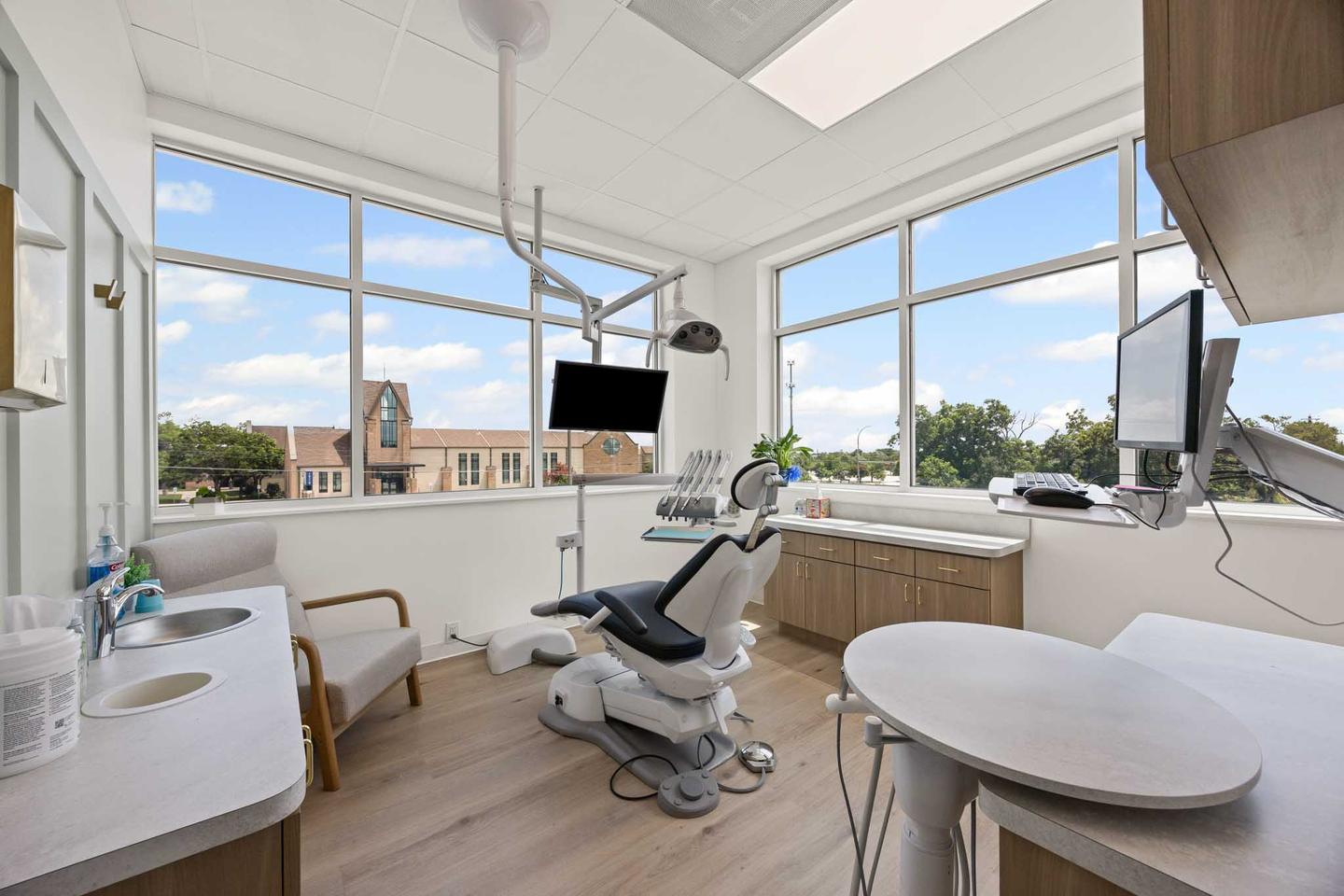 Treatment room in a Westlake practice with a wall of windows looking over the hill country