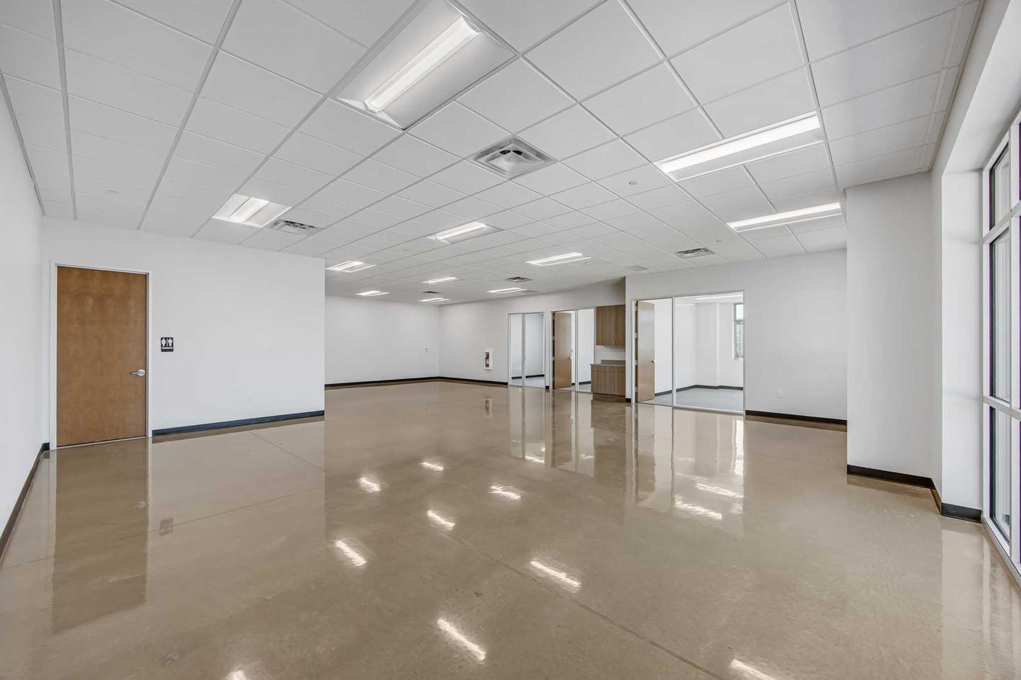 Empty open plan floor in Austin with polished floors, ready to be set for an event