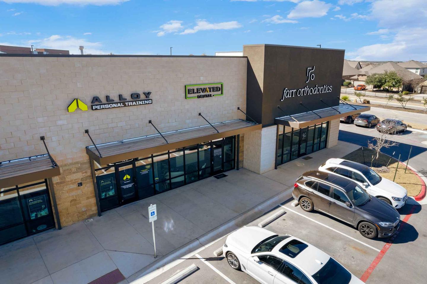 Aerial view of a retail center in Georgetown with its parking court and tenant frontages