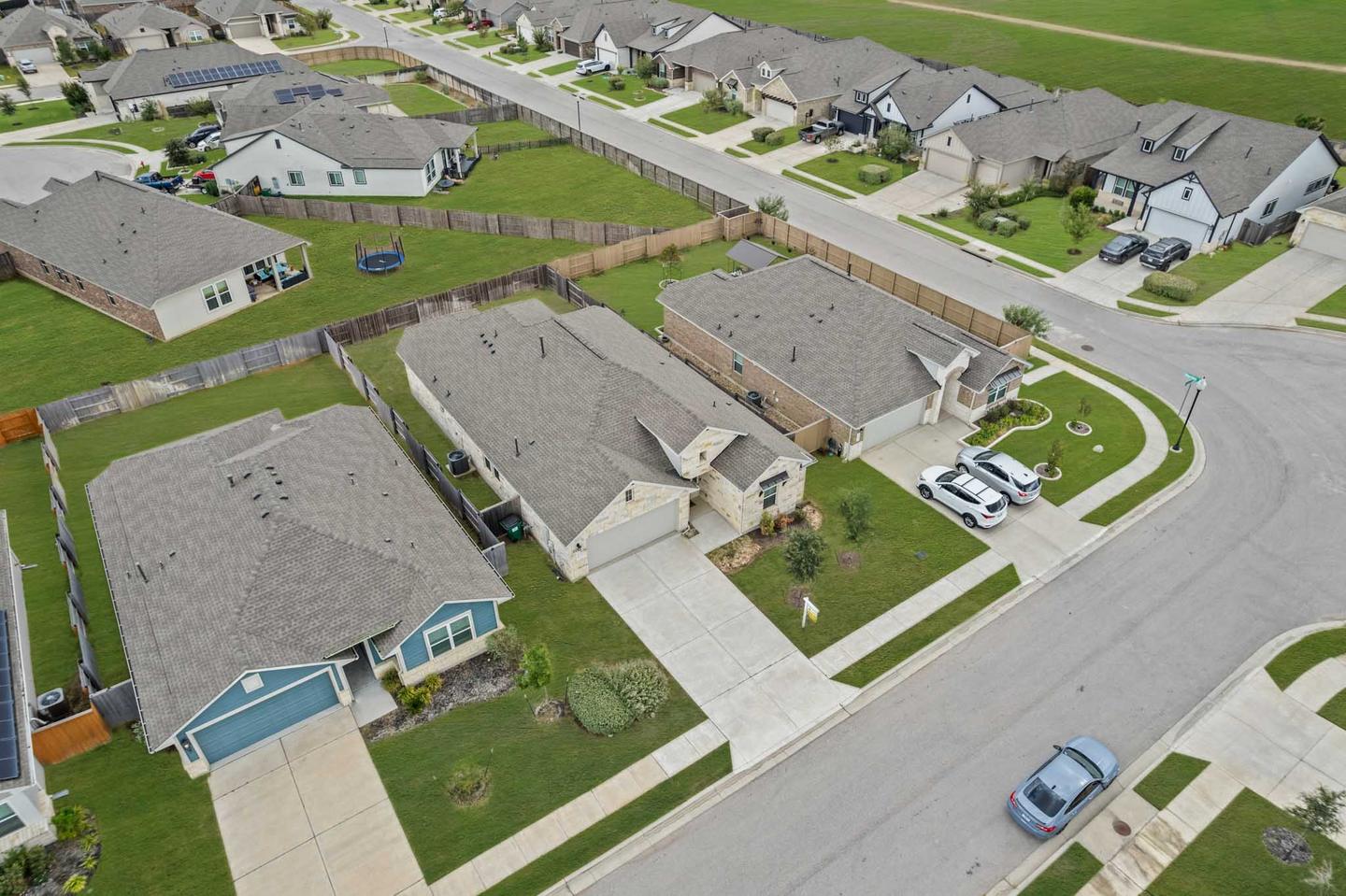 Aerial view of a Bastrop neighborhood showing homes, a swimming pool and the street layout