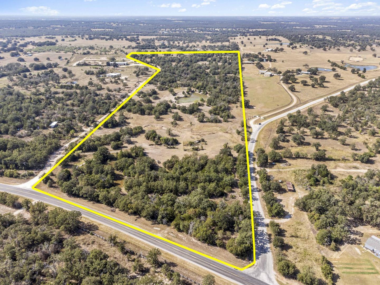 Aerial photograph of a Hill Country parcel with the property boundary drawn on in yellow