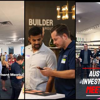 Two attendees talking beside the signage at an Austin real estate investment meetup
