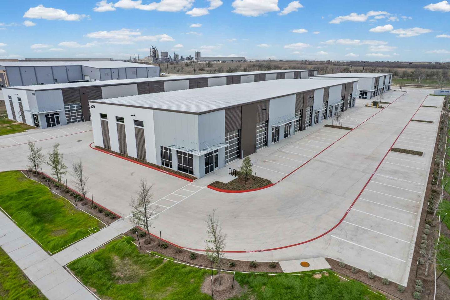 Aerial view of a completed row of new build units in Buda with fresh paving and landscaping