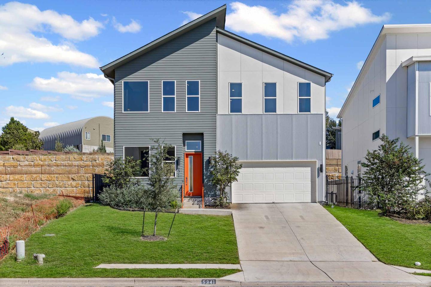 Modern gray and white two story home photographed from the front