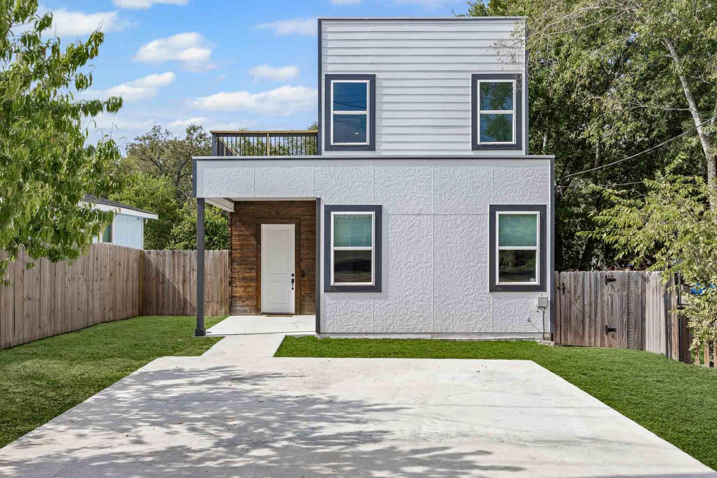 Dark modern two story home in Lockhart photographed from the driveway