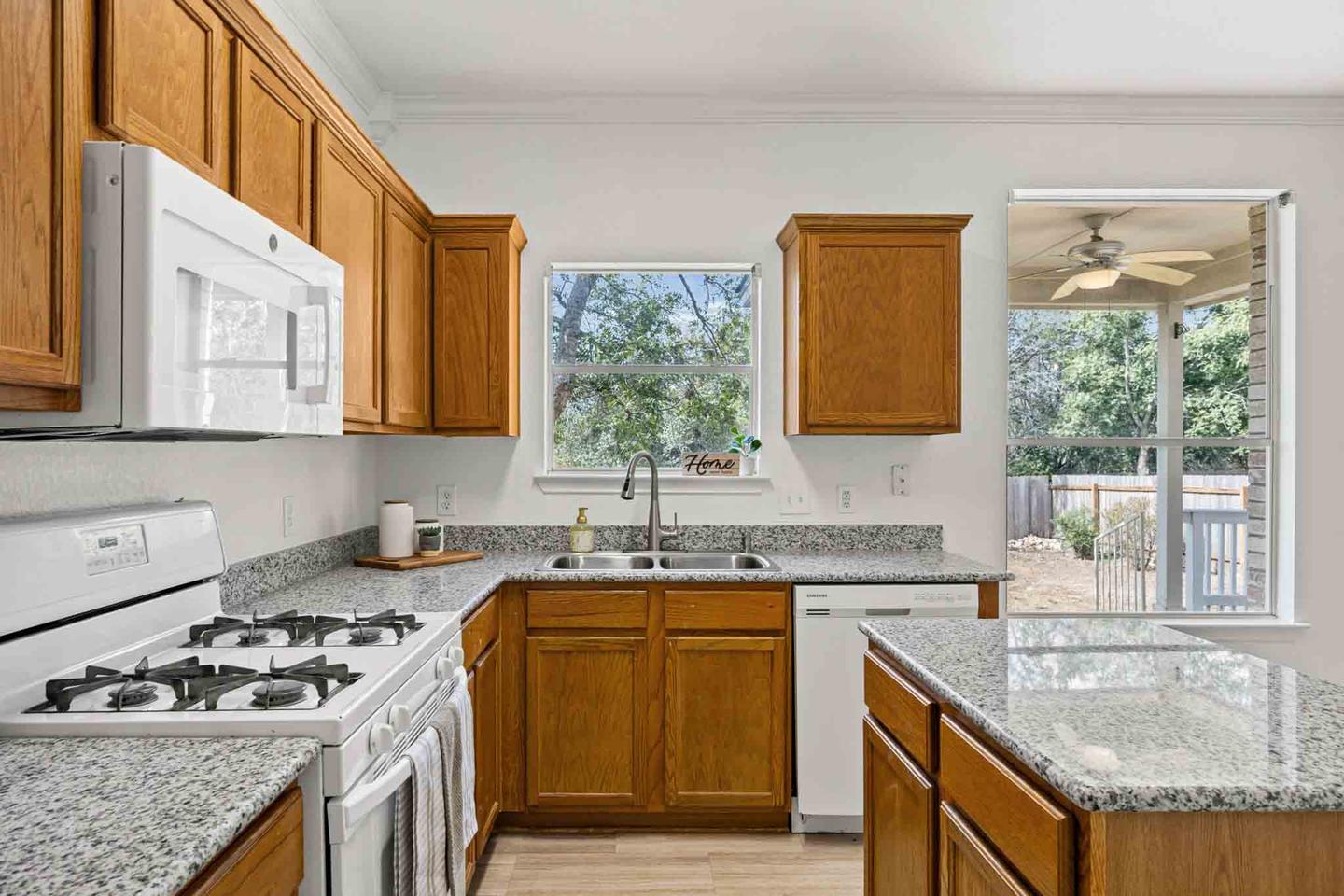 Kitchen in a Round Rock home with oak cabinetry and a window over the sink