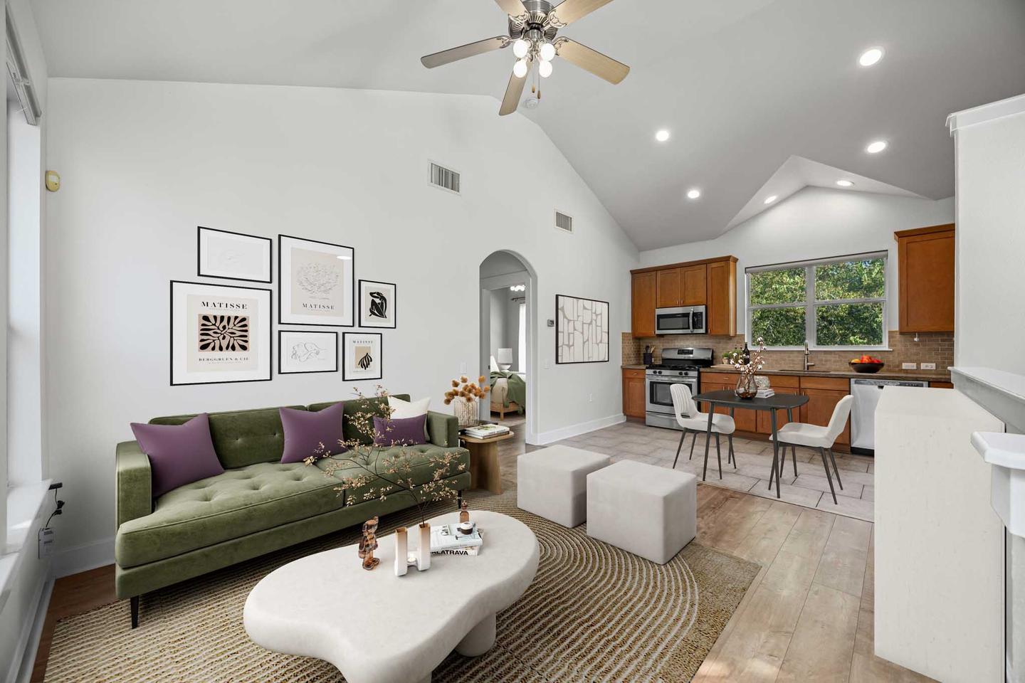 Living room with a green sofa, open shelving and a run of windows along one wall