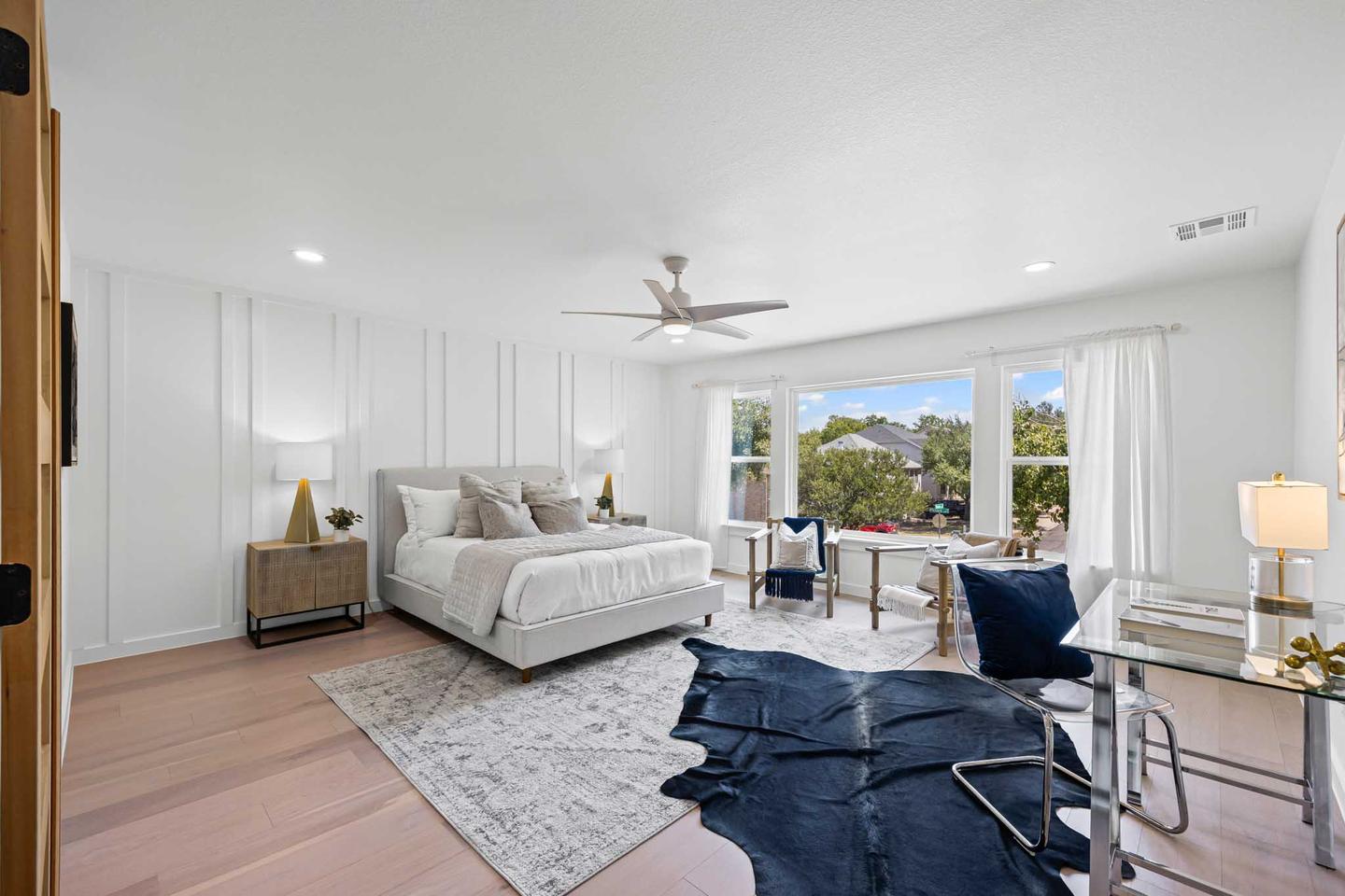 Primary bedroom in South Austin with a vaulted ceiling, a bench at the foot of the bed and bright windows