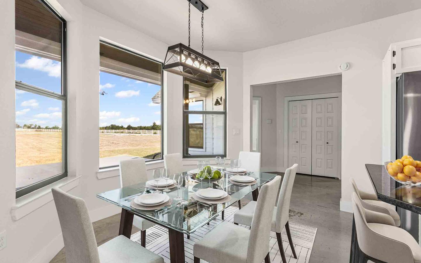 Dining room digitally furnished with a glass table and upholstered chairs
