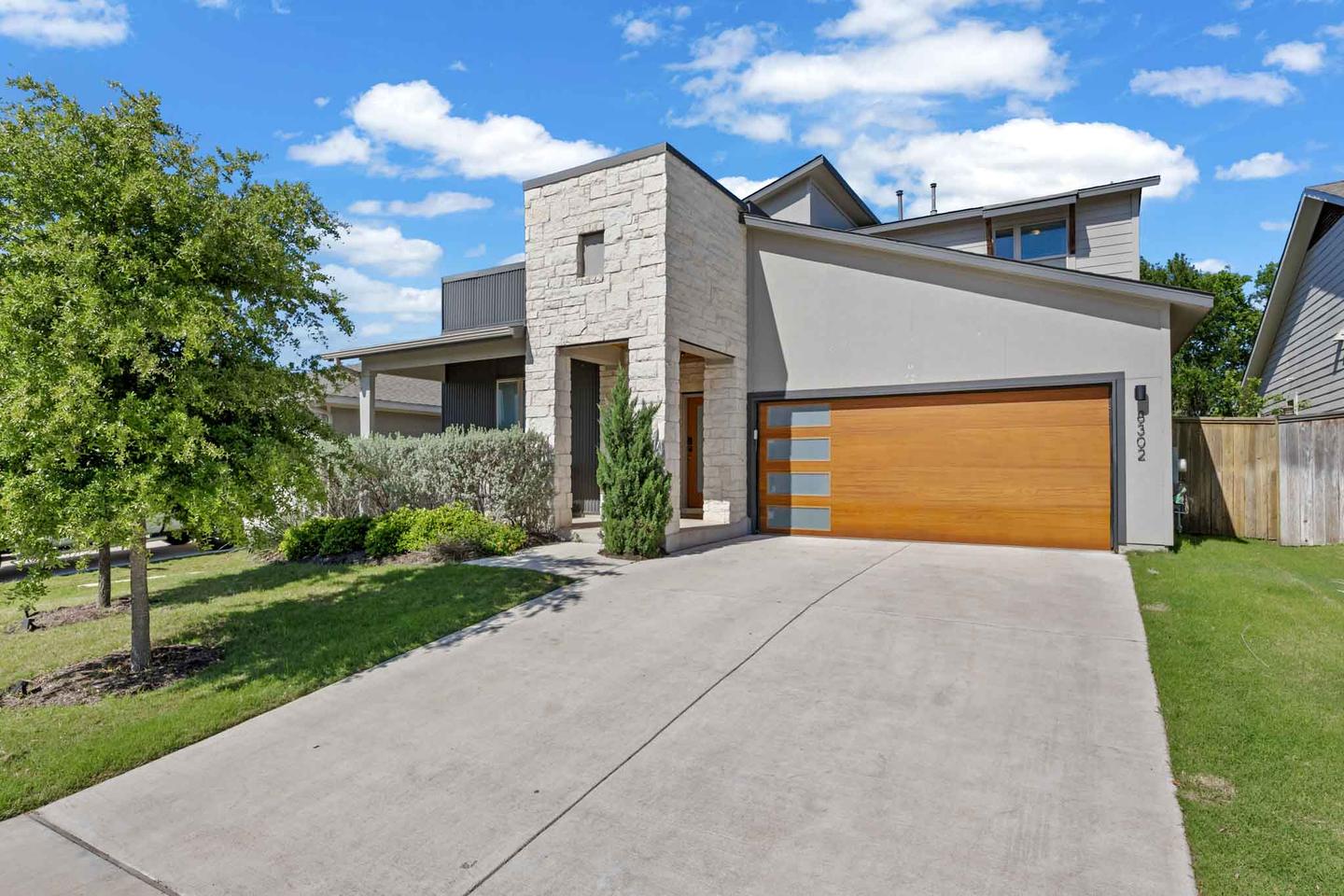 Contemporary gray home in East Austin photographed at midday under a blue sky